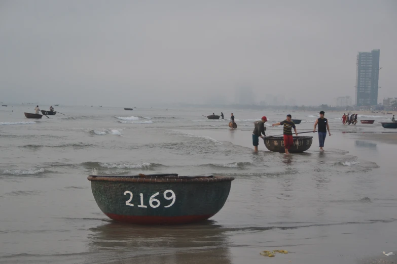 small boats sitting on the beach during the day