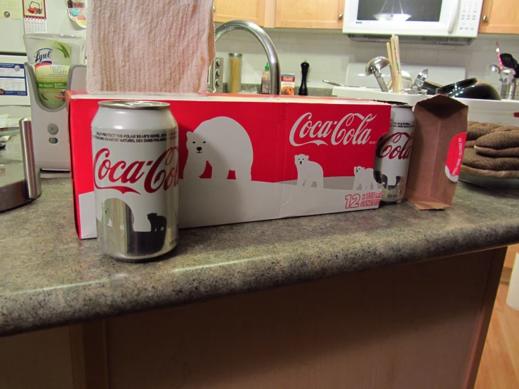 some boxes and cans of drinks on top of a counter