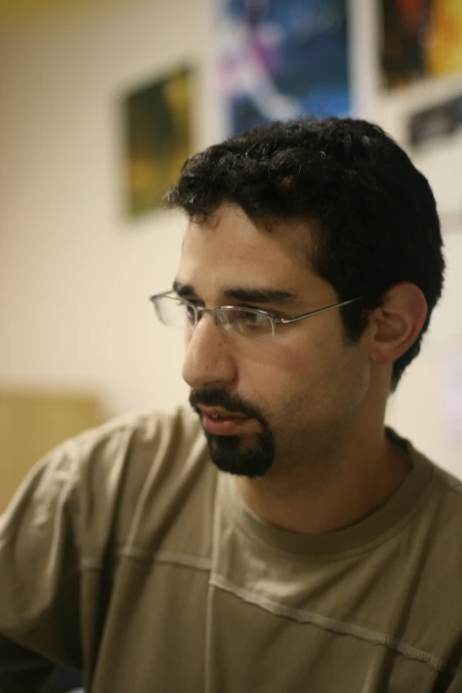 a man looking over his shoulder while wearing glasses