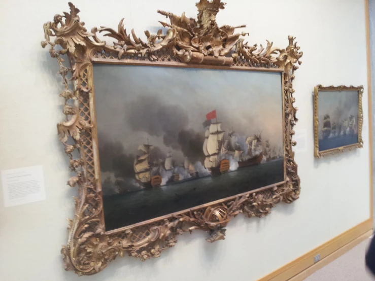 three different paintings on display in a museum