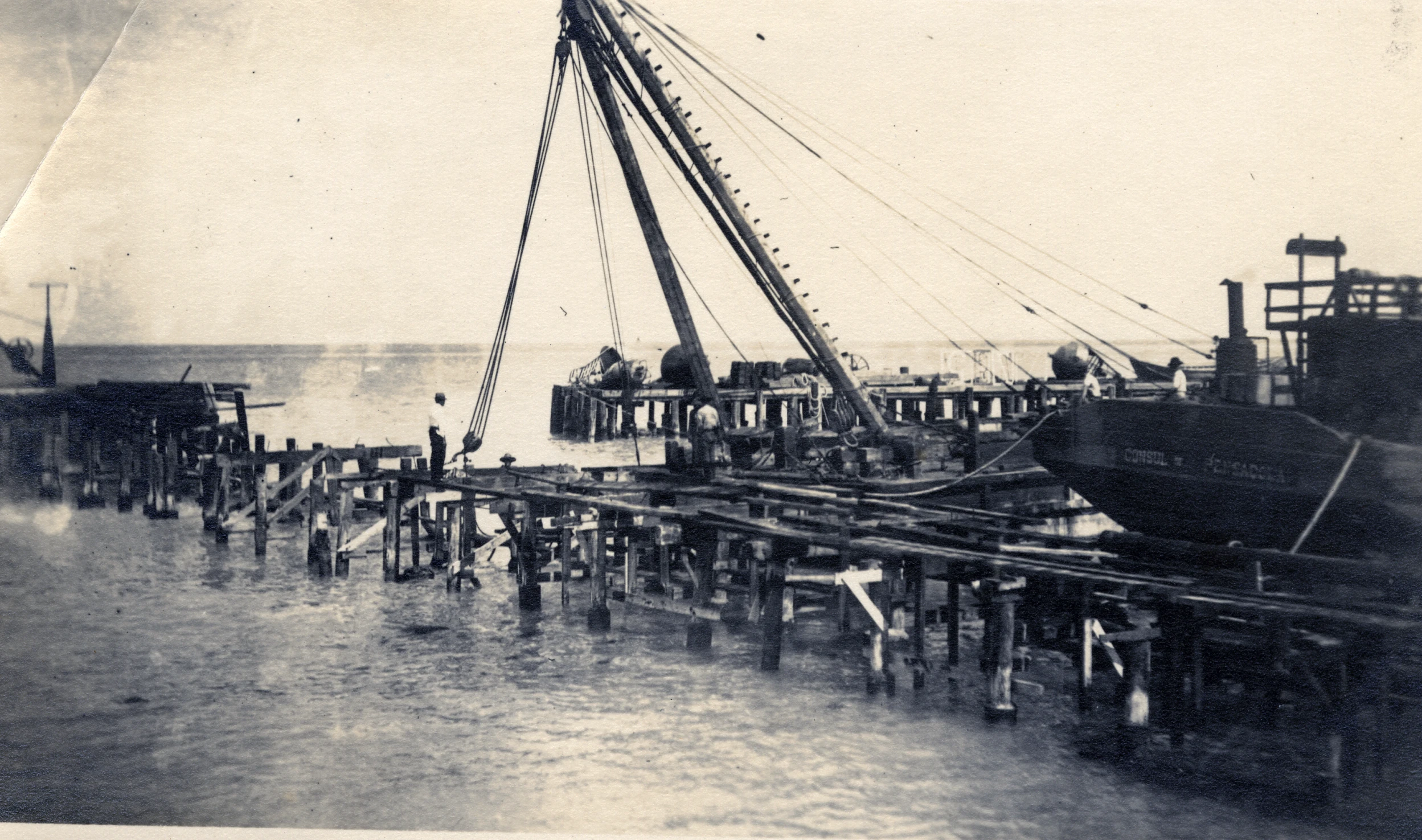 a large boat in the ocean sitting at a dock