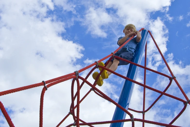 a child climbing on a large obstacle course