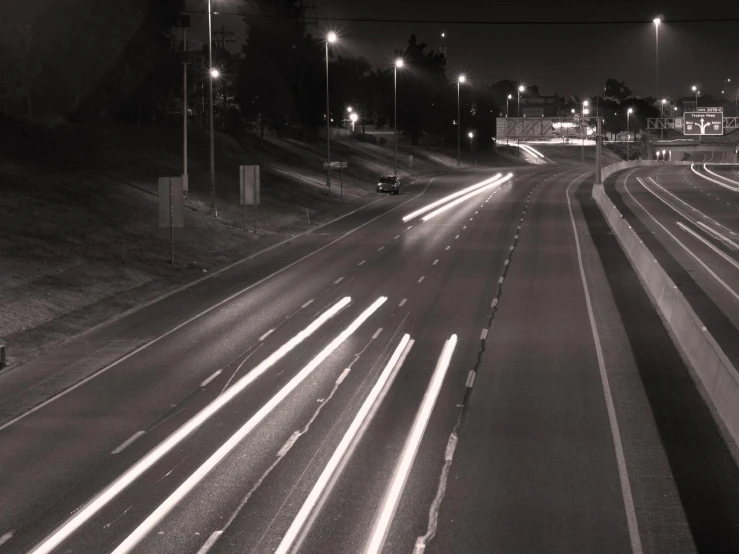 two roads are in black and white with cars