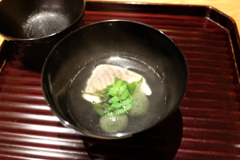 small food items cooking in a wok with chop sticks