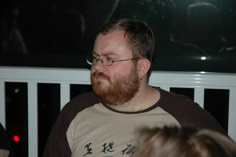 a bearded man is wearing a t - shirt with the word on it