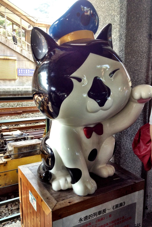 a statue of a cat with a hat and bow tie on