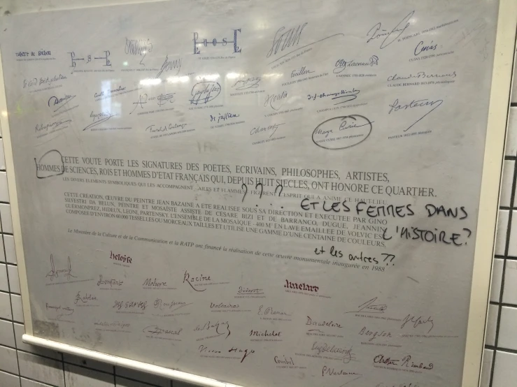 a close up of a white board with writing on it