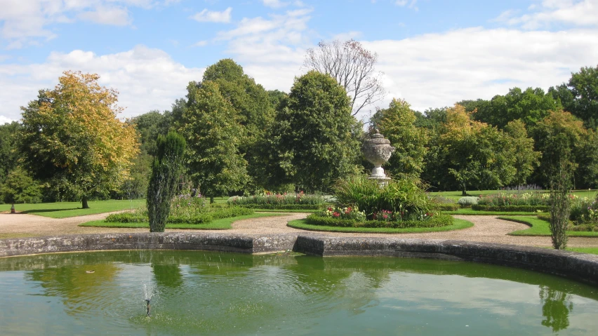 a garden with fountain and lots of greenery