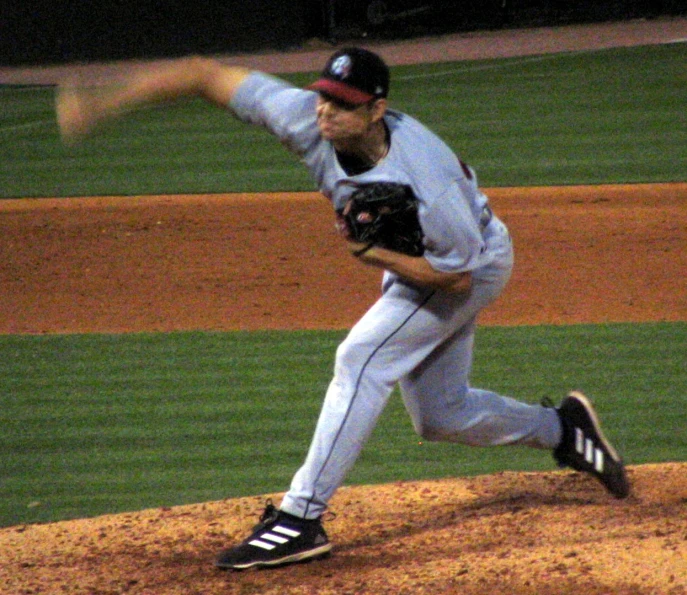 the man is playing baseball on the field