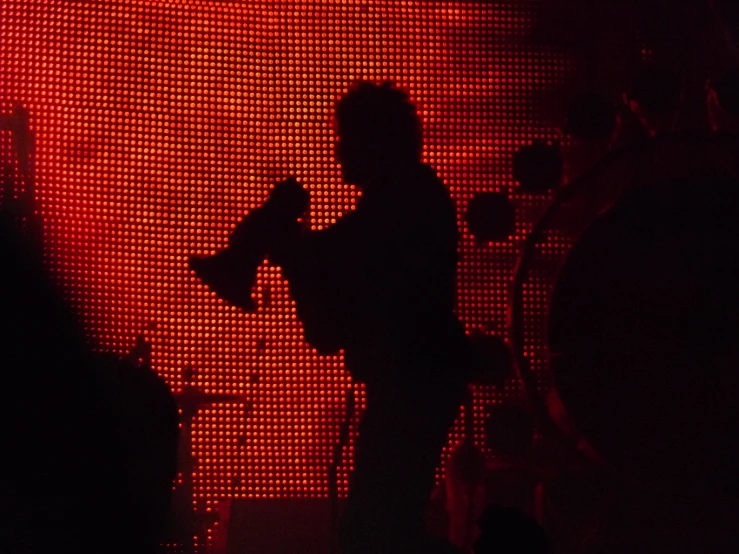 a man standing on a stage with a microphone in his hand