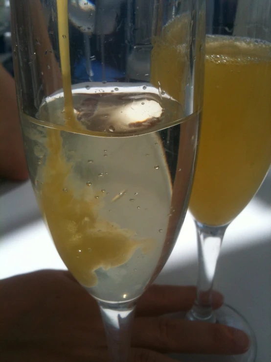 two glasses of sparkling champagne are near one another