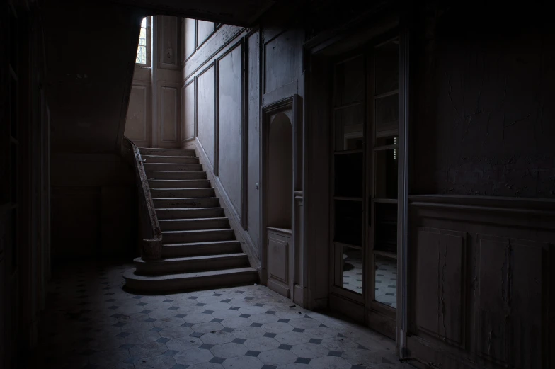 a staircase leading up into a hallway with windows