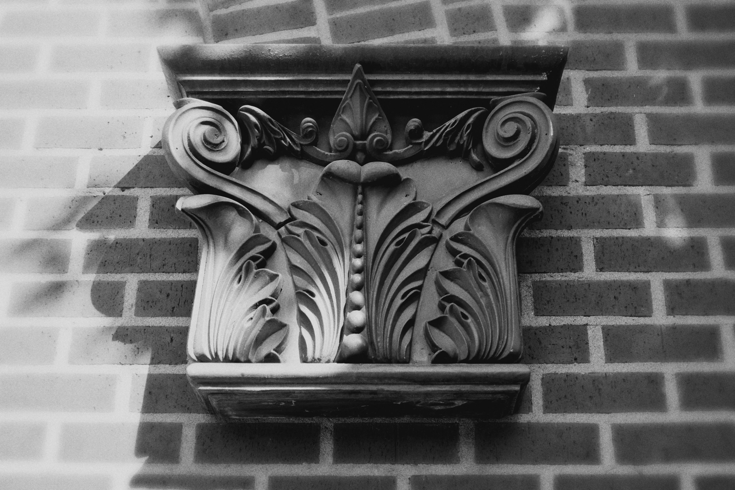 the corner of an old decorative object on a brick wall