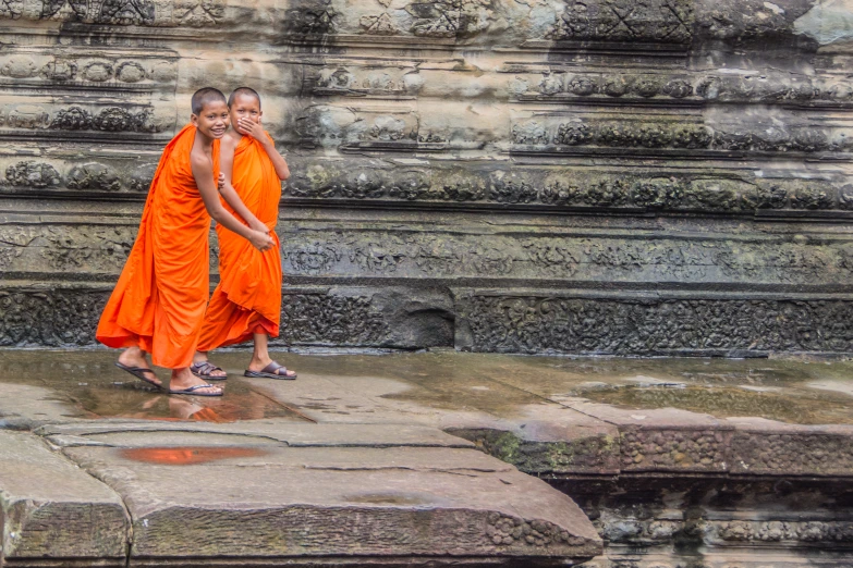 two monks walking down an old path together