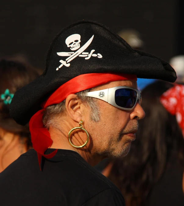 a man wearing pirate costume looking off in distance