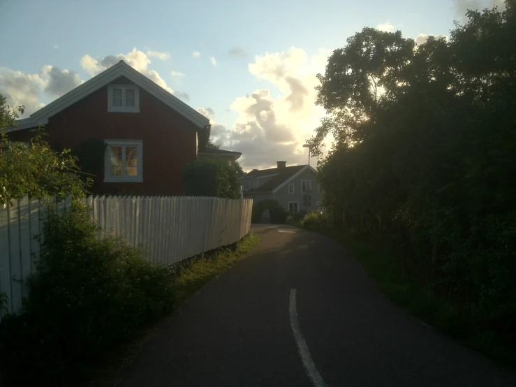the sunset behind a house in the countryside