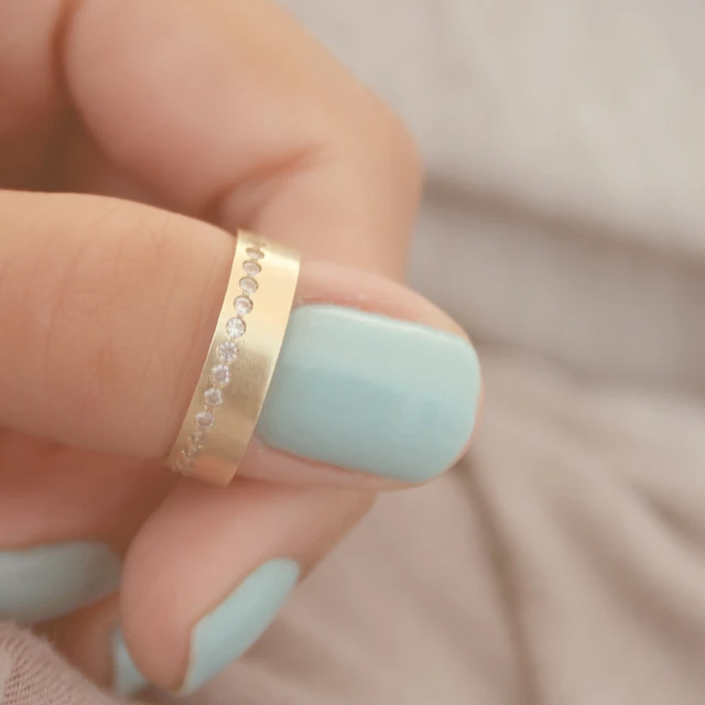 woman with nail polish and ring in her hand