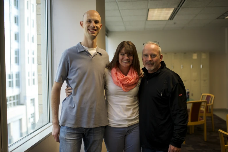 a group of people standing in front of a window