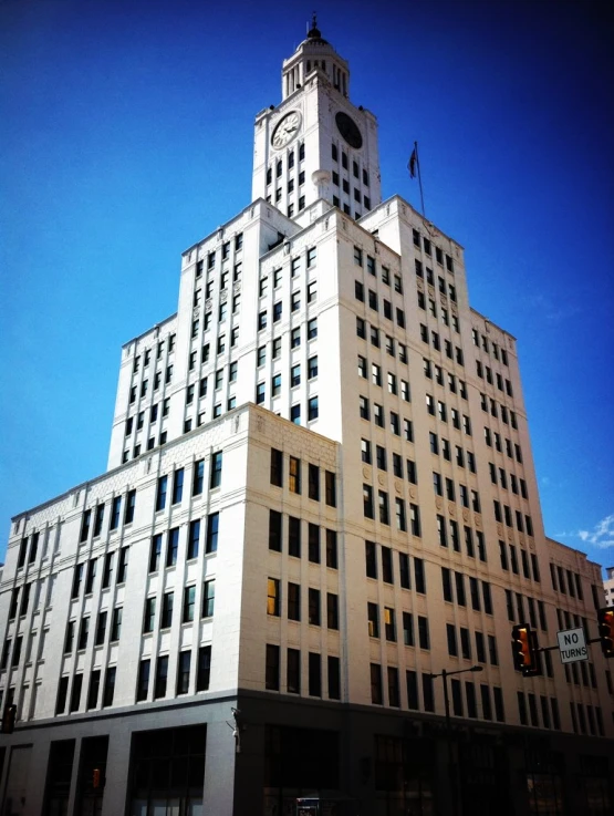 tall white building with a clock tower in front