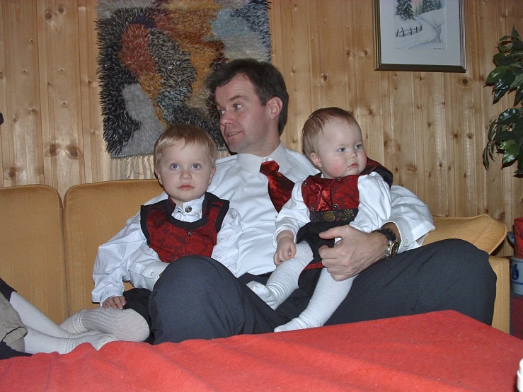 a man with two small children in his lap