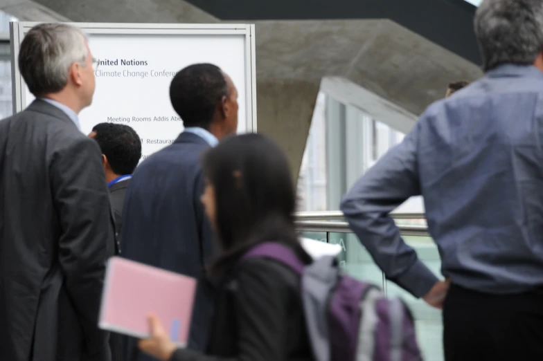 business people are on a busy hallway talking