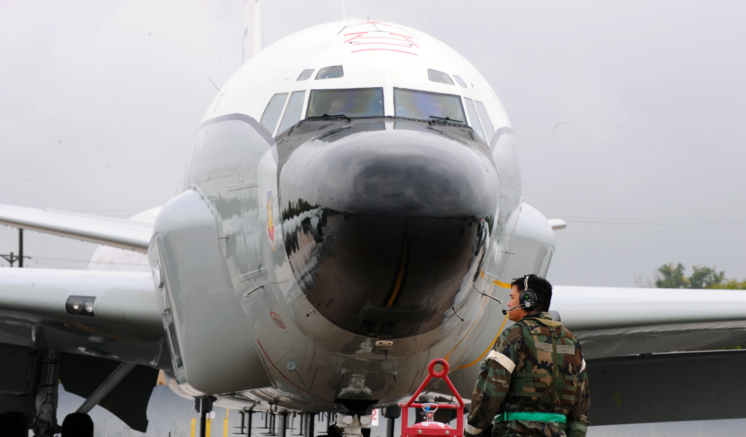 the soldier is looking at the large airplane