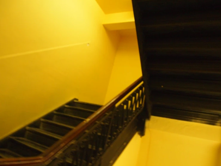 a view of a stairway with black and yellow paint