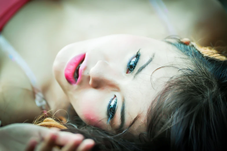 a close up of a woman with red lipstick on her cheek