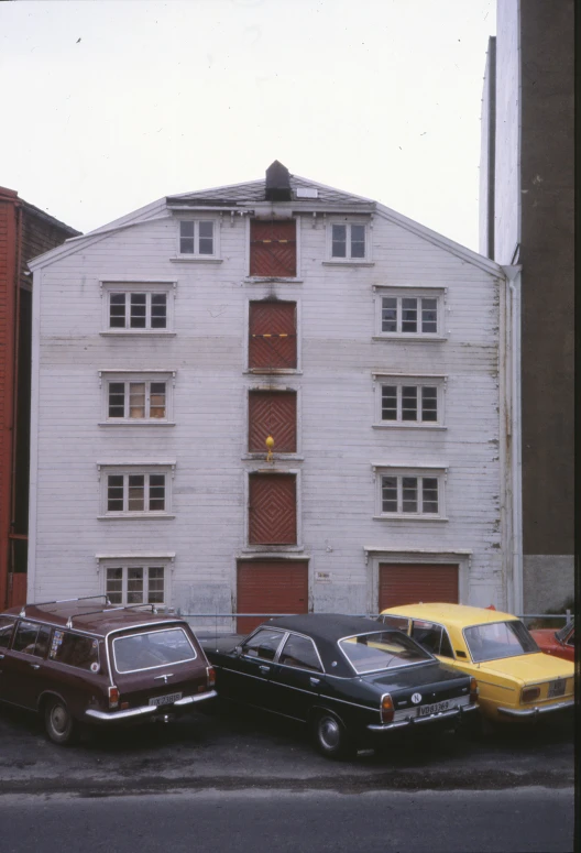 three cars parked next to each other on a city street