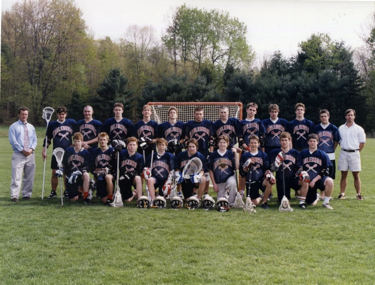 a lacrosse team is posed for a po