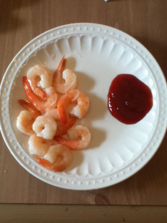 the shrimp is in pieces on a white plate