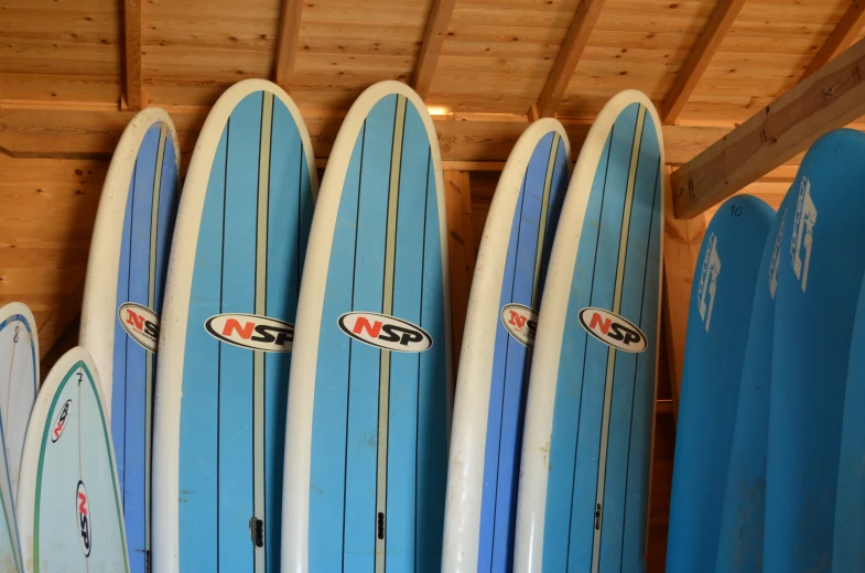 a group of blue and white surfboards sitting on display