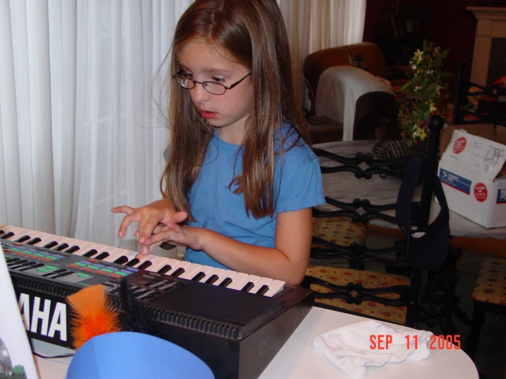 a  sitting at a piano playing an organ