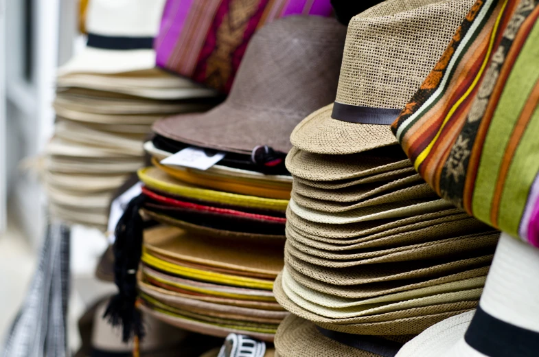 many different hats are arranged together on display