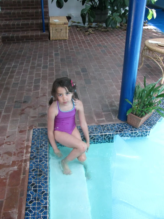a  is sitting at the edge of a pool