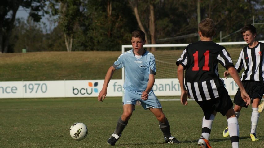 the young men are playing soccer on the field