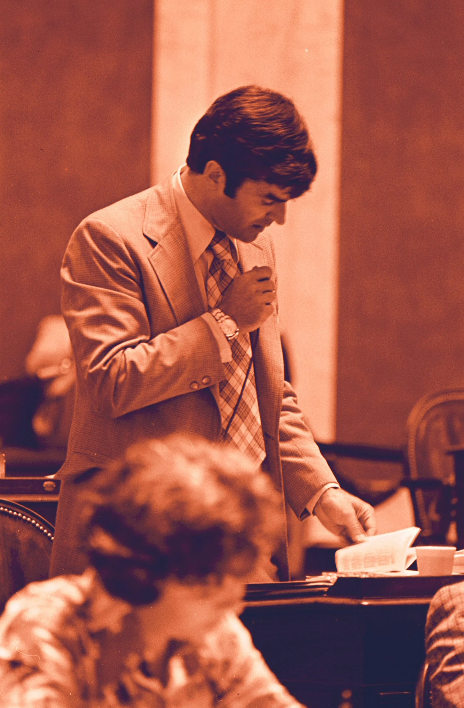 an old man is standing in a courtroom