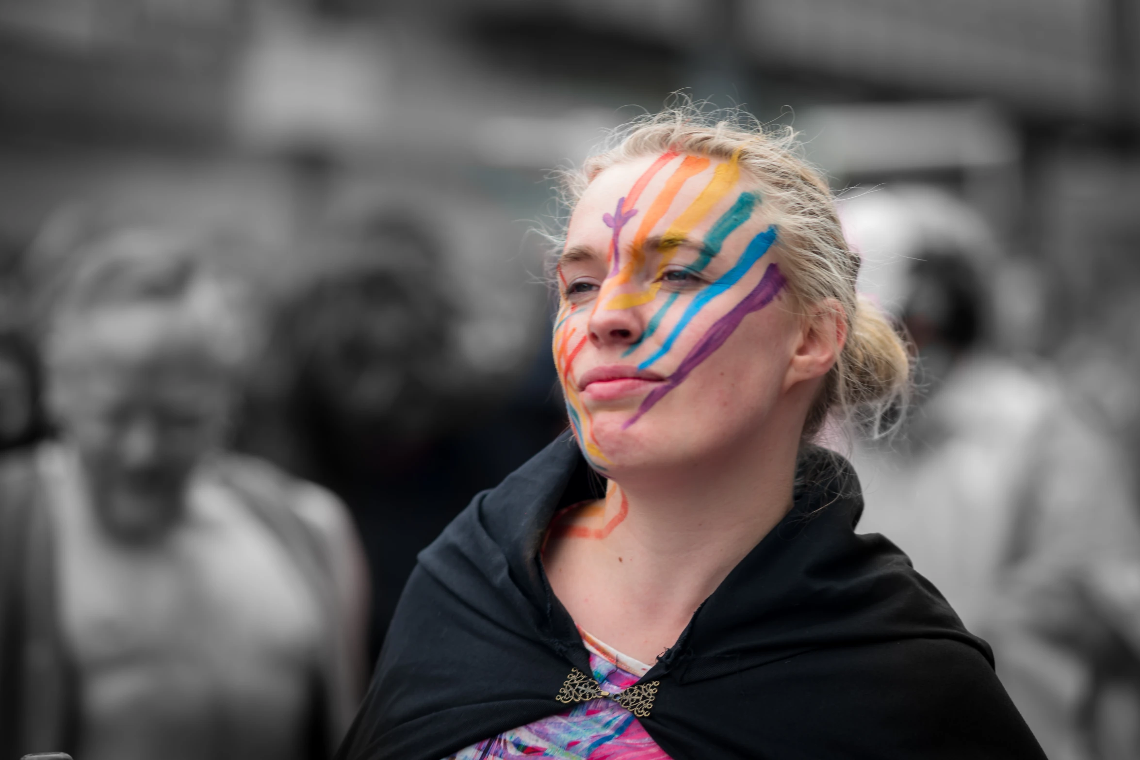 the woman has painted on her face with different colors