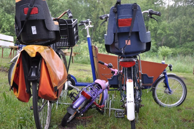 two bikes are parked outside in a field