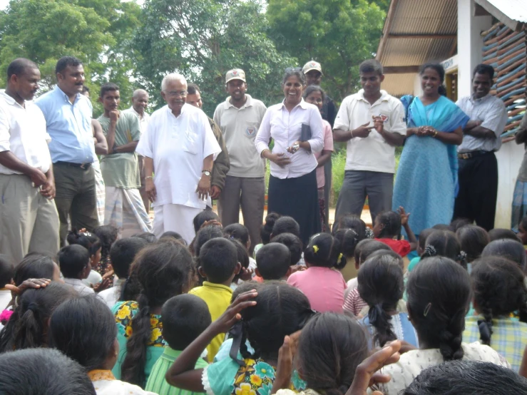 a group of people standing in front of an audience