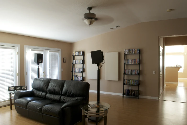 a black couch some books and a lamp