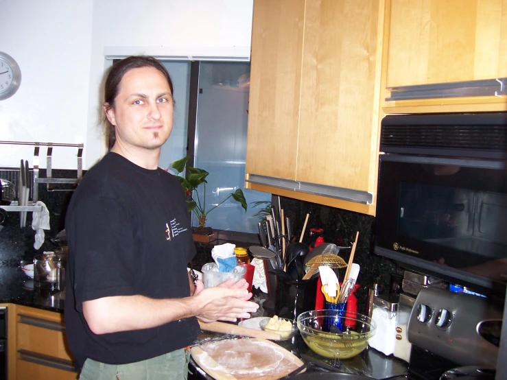 a man in black shirt making a pie