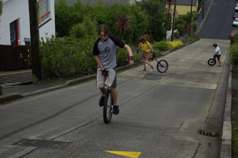 s are learning to ride their bikes down the street