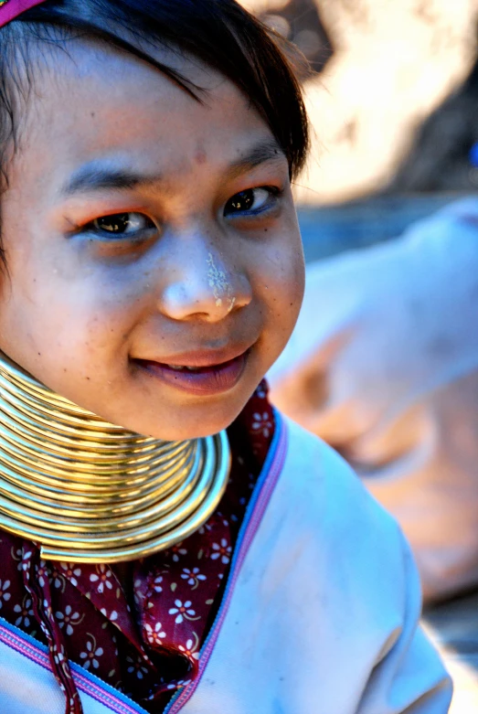 there is a child with a large necklace on her neck