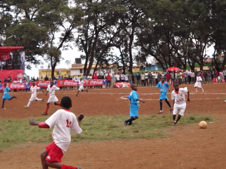 a group of boys playing a game of soccer