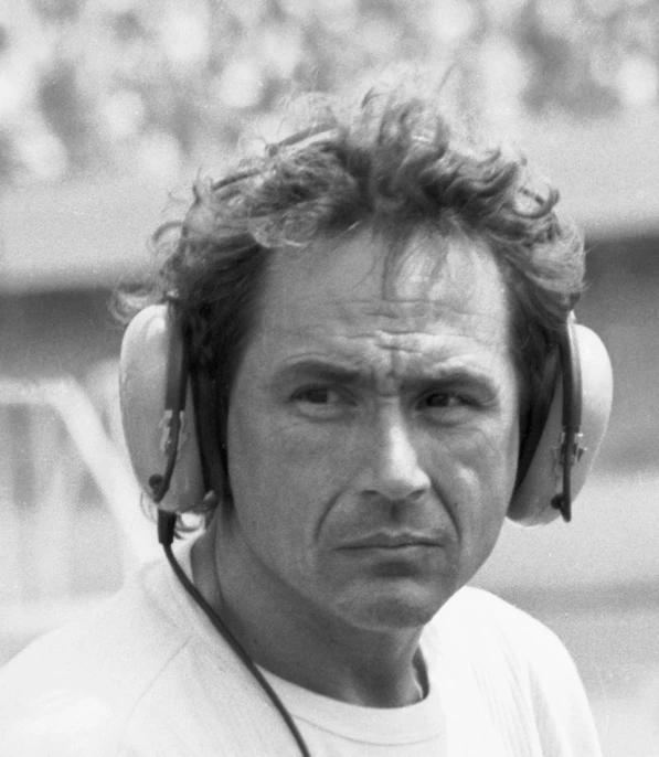 man with headphones on standing in front of a baseball