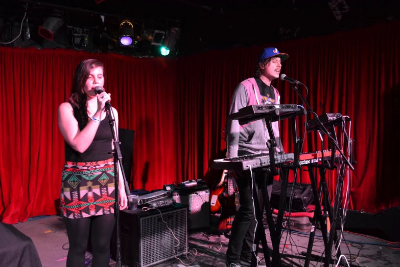 two people that are standing next to a keyboard