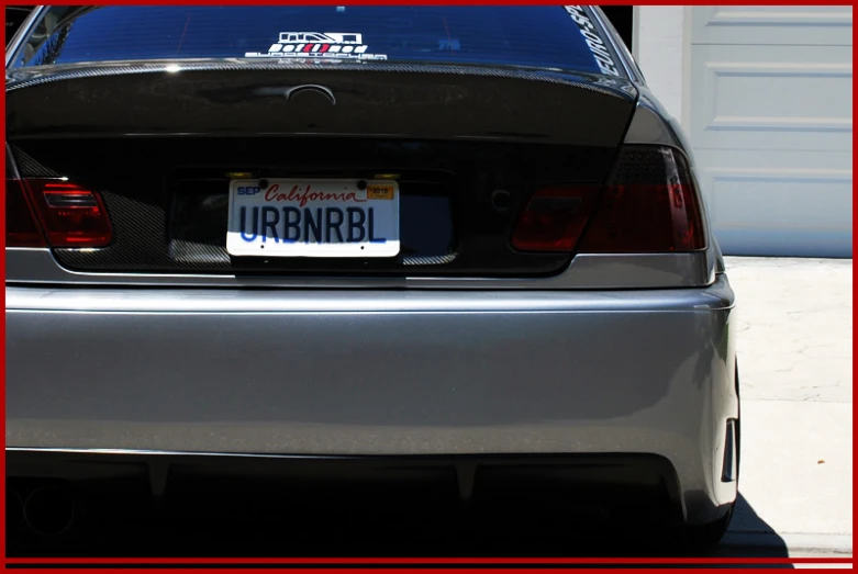 the license plate of a silver car reads irdbnari