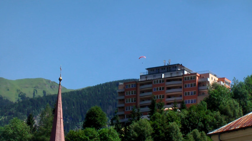 a few buildings sit high above some trees