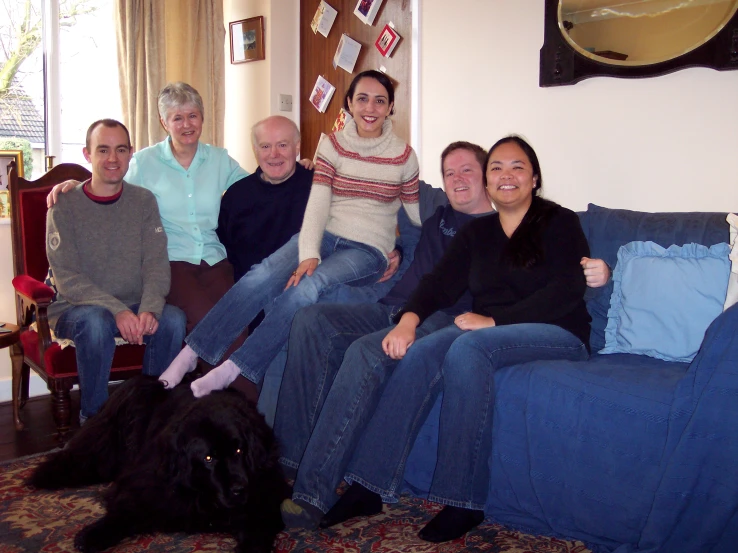 a group of people sitting around each other on a couch